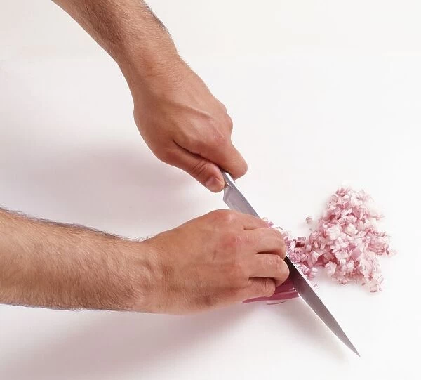 Chopping red onions with knife, close-up