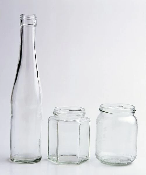 Clear glass bottle and two clear glass jars