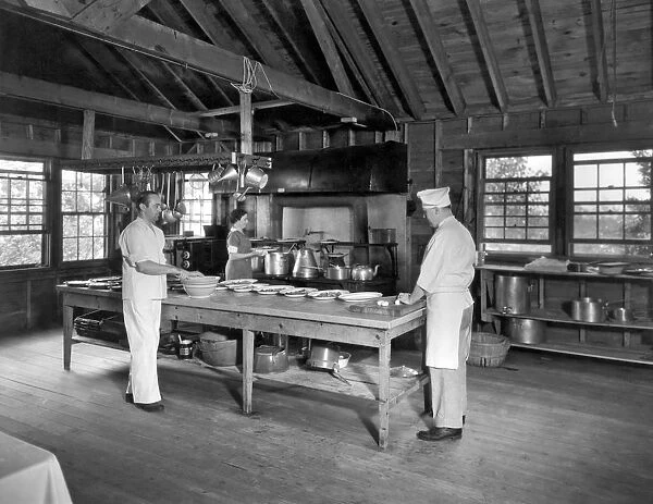 The cooks and staff at a Girl Scout camp preparing dinner for the girls