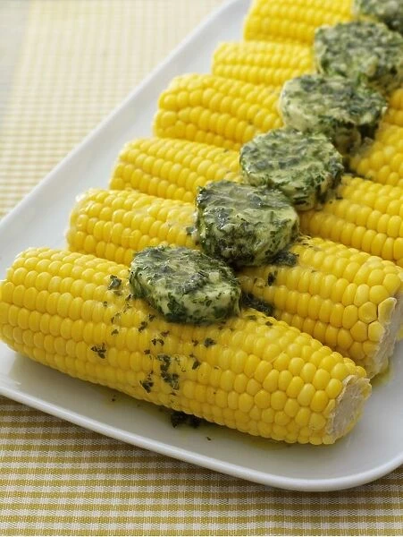 Corn on the cob topped with herb butter