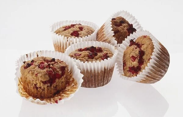 Five cranberry muffins in paper cases