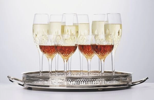 Cut glass glasses on serving tray, containing champagne and sherry