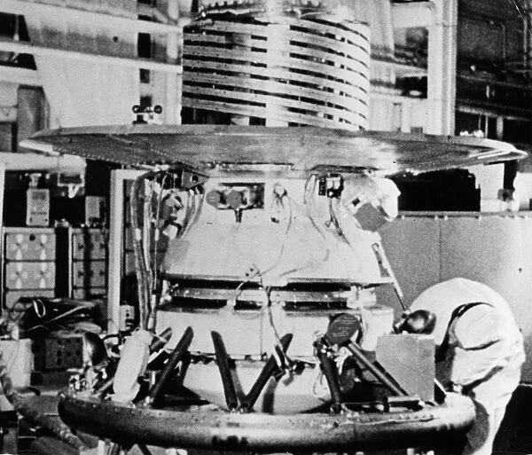 The descent capsule of the soviet space probe venera 9 being worked on in the assembly shop, 1975