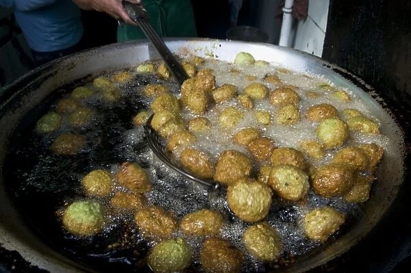 Egypt, Cairo, taamiya (falafel) being cooked in hot oil at food stall