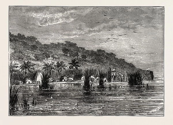 AN ENCAMPMENT ON THE SHORES OF LAKE TANGANYIKA, an African Great Lake. The lake is