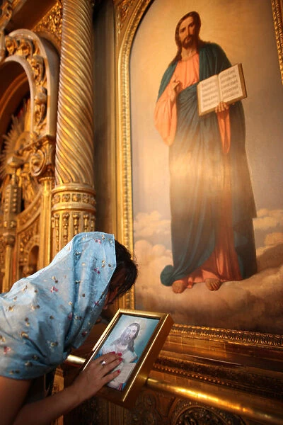 Faithful touching an icon in St Stephens Bulgarian church