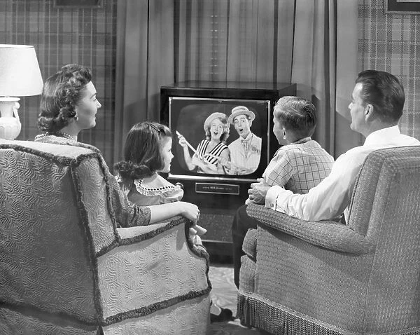 Family gathered around the television, 1950-60s, black and white