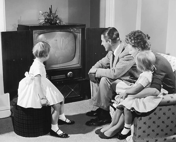 Family gathered around television