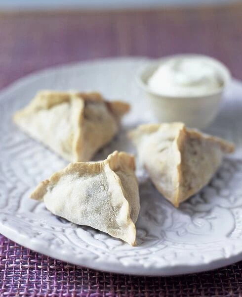 Fatayer Bisabanikh, Lebanese spinach pastry parcels on plate, with yoghurt dip