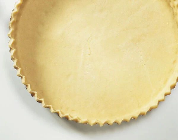 Flan tin lined with uncooked pastry, section close up