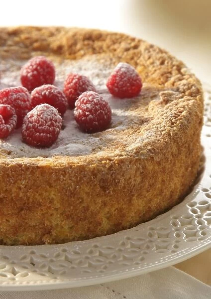 Flourless almond orange cake topped with fresh raspberries