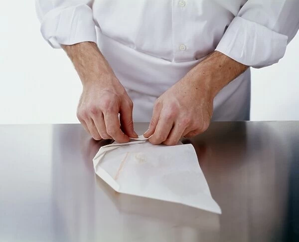 Folding over edges of baking parchment (en papillote), close-up