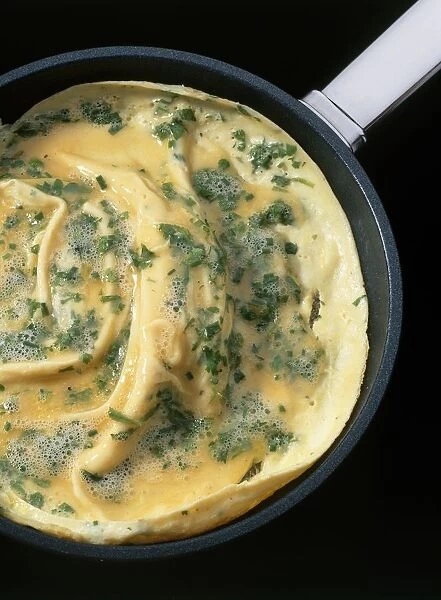 French omelette cooking in frying pan