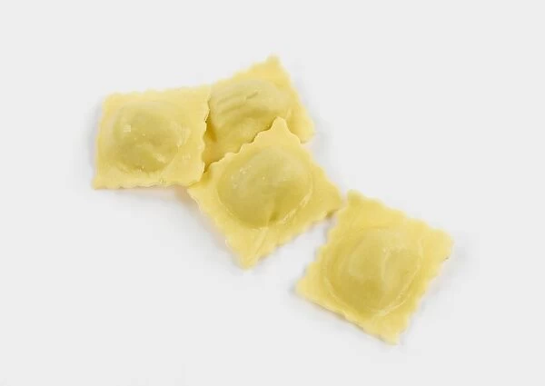 Fresh ravioli pasta against white background