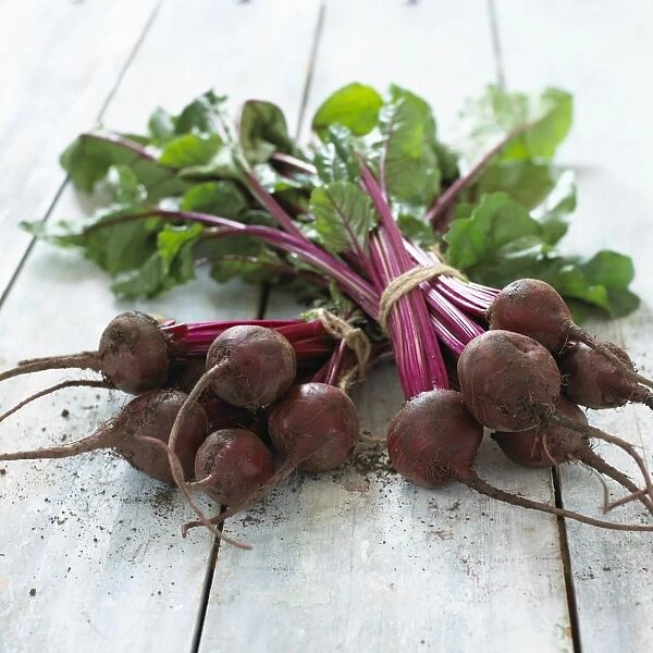 Freshly picked bunches of beetroot on wooden table