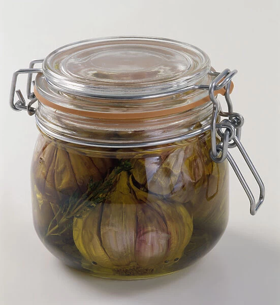 Garlic preserved in transparent airtight glass jar, close-up