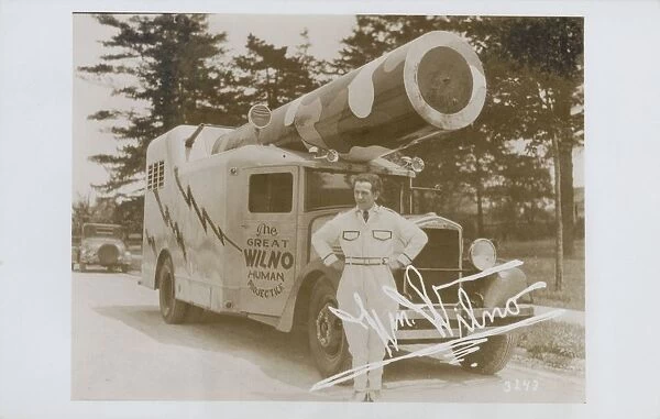 The Great Wilno. ca. 1935, USA, The Great Wilno, a human cannon ball, stands beside his specially designed truck mounted cannon