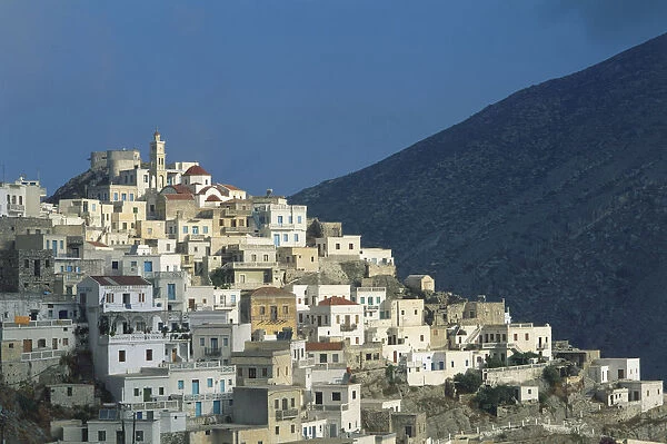 Greece, Karpathos, historical village of Olympos, sitting high in the hills of northern Karpos, brightly coloured houses and church at the top