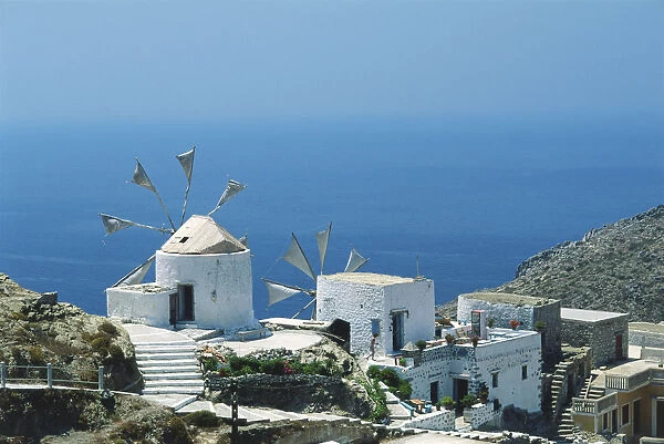 Greece, Karpathos, Olympos, cliff-top whitewashed windmills overlooking the sea