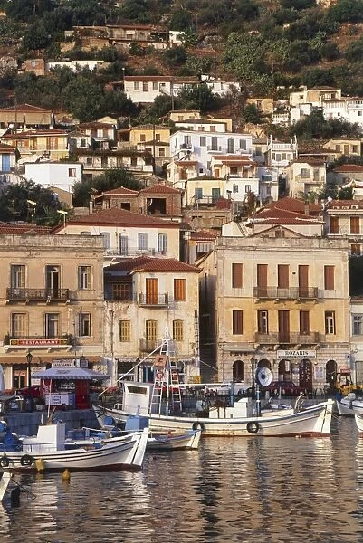 Greece, Mani Peninsula, boats moored in harbour below buildings on hillside