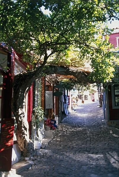 Greece, narrow cobblestone alley lined with buildings