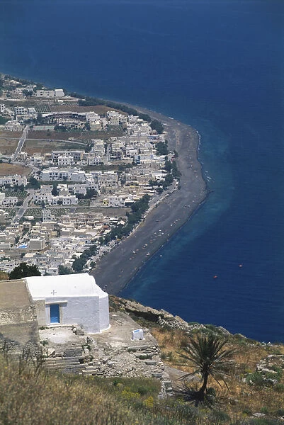Greece, Santorini, aerial view from ancient Thira down to Kamari, curved beach with black volcanic sand