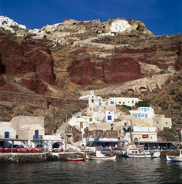 Greece, Santorini, Ammoudi fishing village overlooked by Oia on the cliff top above