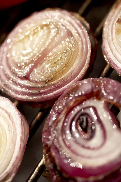 Grilled red onions on barbeque grill