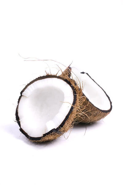 Two half coconuts against white background