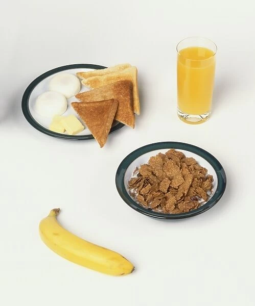 A healthy breakfast of poached eggs, toast, cereal, banana and glass of orange juice