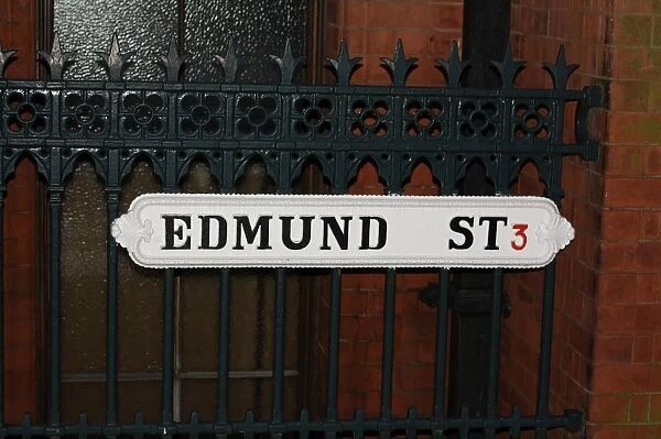 Historic city street sign and fence