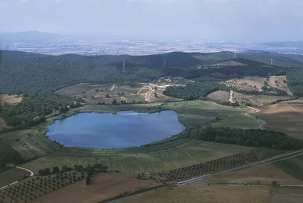 Italy, Tuscany, Grosseto, Lake Lago dell Accesa and surrounding Metalliferous Hills with Follonica in background