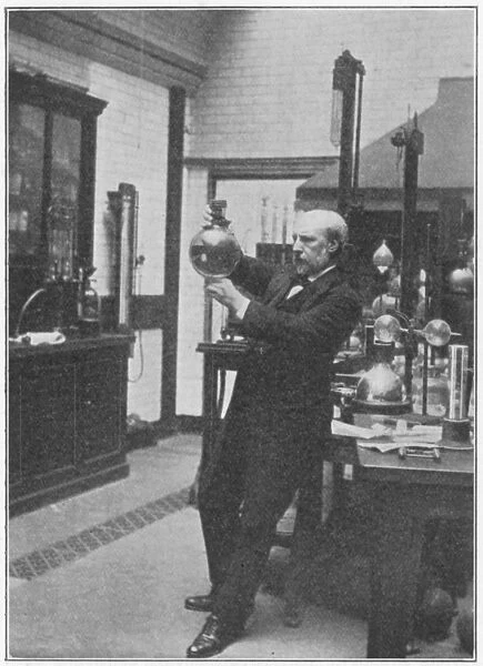 James Dewar (1842-1923) in his laboratory holding one of his vacuum flasks. Scottish chemist