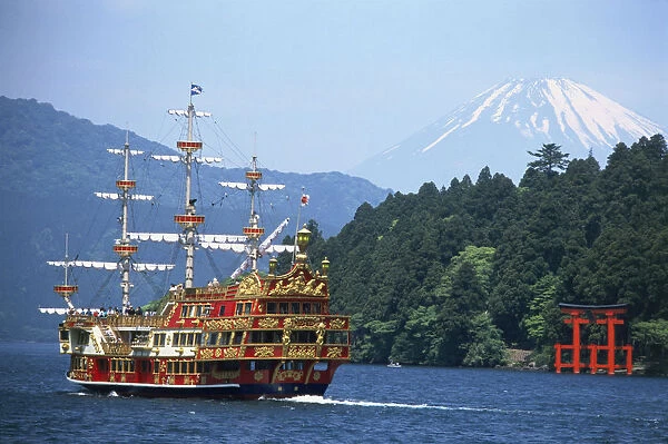 Japan, Central Honshu, motorised sailing ship on Lake Ashi with snow-capped Mount Fuji in background