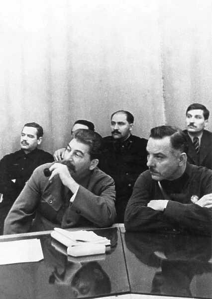 Joseph stalin (front, left) sits with k, e, voroshilov at a conference of best combine workers and soviet government, left to right, back: a, a, andreyev, l, m, kaganovich, v, j, chubar, ussr, 1930s