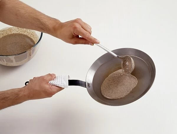 Ladling pancake batter onto frying pan (making buckwheat pancakes), close-up
