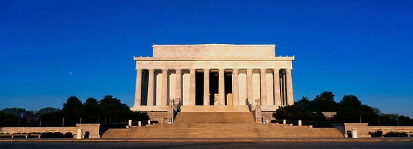 This is the Lincoln Memorial in morning light. We see the wide steps leading up to the columns of the Memorial against a blue sky