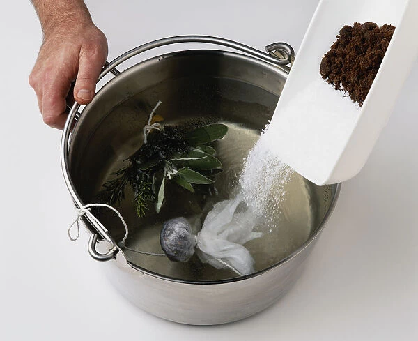 Making Brine, Water in steel pan with herbs and salt being added (making brine)