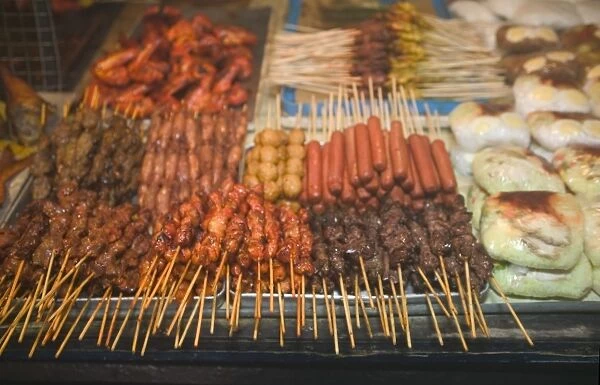 Malaysia, Sarawak, Sibu, grilled satay meat for sale at market stall, close-up