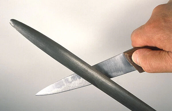 Man sharpening knife, close-up