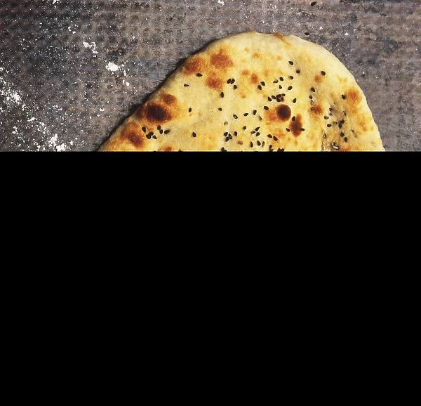 Naan bread sprinkled with Nigella seeds, view from above