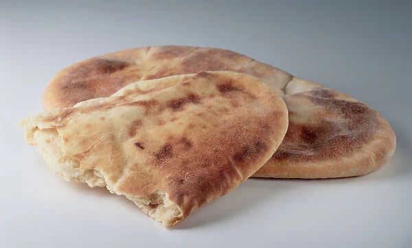 Naan, Punjabi flat bread with a piece torn from it