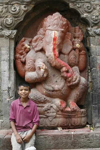 Nepalese boy and Ganesh statue