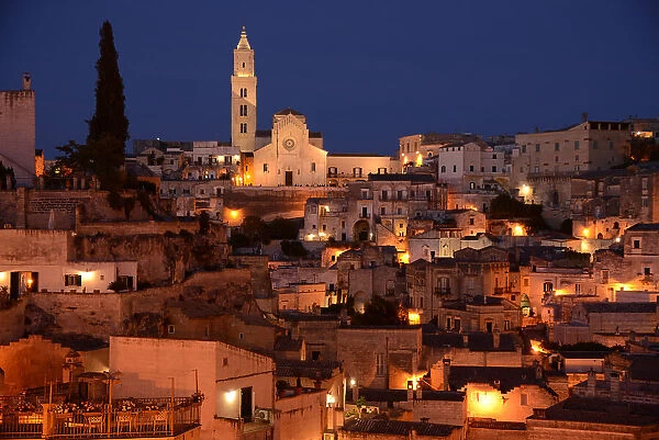 At night with suggestive lights the Pontifical Basilica Cathedral of Maria Santissima della Bruna and Sant'Eustachio dominates the view over Matera. Matera is a city located on a rocky outcrop