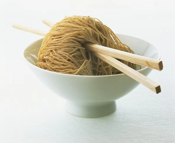 Noodles in a bowl, two chopsticks sticking through the centre of the noodles