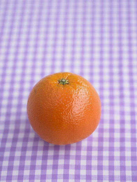 Orange on purple gingham surface