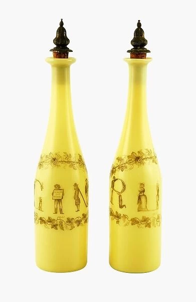 Pair of Richardsons yellow glass decanters, with silver gilt stoppers, decorated