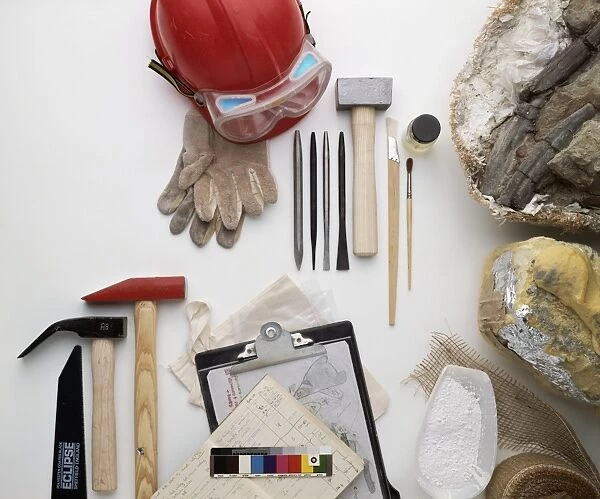 Palaeontologists equipment, including hammers, chisels, hard hat, gloves, clipboard, documents