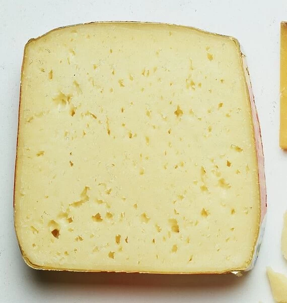 Pale yellow tilsit cheese, an accidental discovery made of pasteurized milk, with a medium texture and irregular holes and cracks throughout. Often used in sauces and served with vegetables. Pungent flavor increases with age