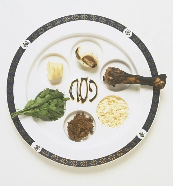 Passover meal or Seder plate, displaying traditional bitter herb, egg, meat leg, charoset, green vegetables